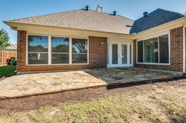 1521 Merritt Dr, Flower Mound, TX 75028 - rear view of property featuring brick siding, french doors, a patio, fence, and a shingled roof