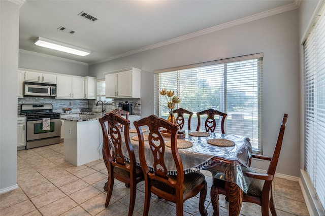 1521 Merritt Dr, Flower Mound, TX 75028 - dining space with ornamental molding and light tile patterned floors