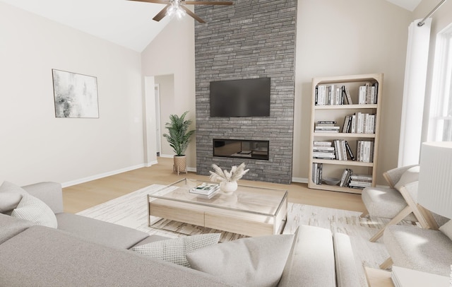 living area featuring a stone fireplace, baseboards, ceiling fan, and wood finished floors