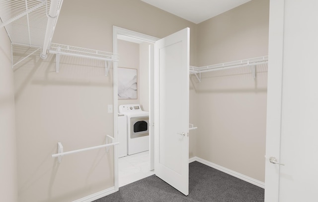 walk in closet featuring washer / dryer and carpet flooring