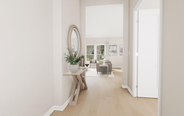 corridor with baseboards and light wood-style flooring