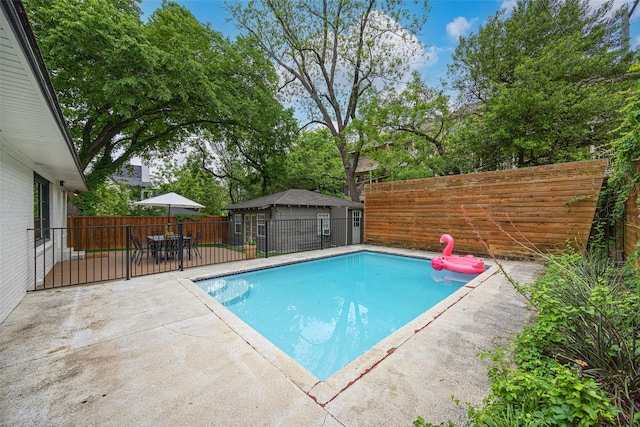 view of pool with a fenced in pool, outdoor dining space, a fenced backyard, and a patio area