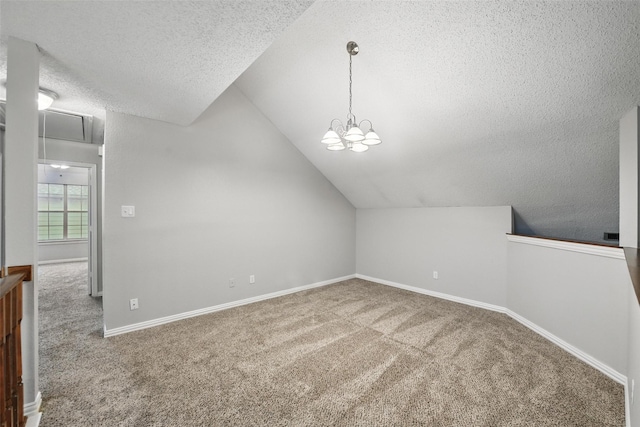 additional living space featuring baseboards, carpet, a textured ceiling, and lofted ceiling