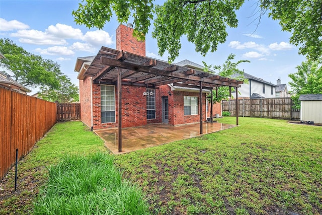 back of house with a fenced backyard, a pergola, a lawn, and brick siding