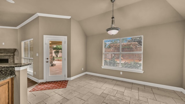 interior space featuring stone tile floors, baseboards, vaulted ceiling, and a fireplace