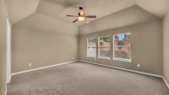unfurnished room featuring baseboards, a ceiling fan, carpet, and vaulted ceiling