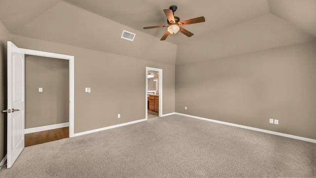 unfurnished bedroom featuring visible vents, lofted ceiling, baseboards, ceiling fan, and carpet