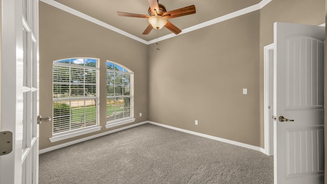 spare room featuring crown molding, carpet flooring, baseboards, and ceiling fan