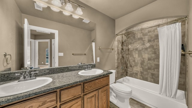 full bath with visible vents, a sink, toilet, and shower / tub combo