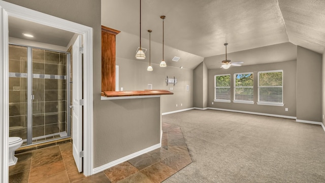 kitchen with ceiling fan, decorative light fixtures, vaulted ceiling, carpet floors, and baseboards