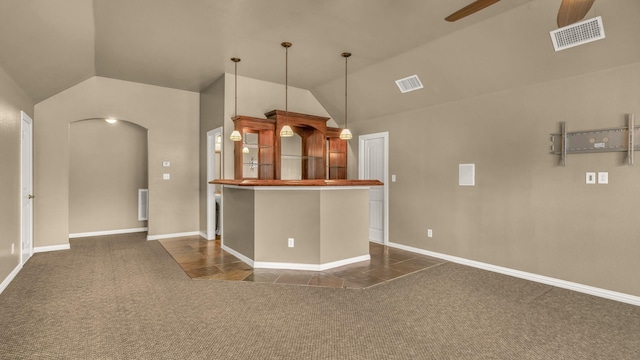 kitchen with a ceiling fan, visible vents, lofted ceiling, and dark colored carpet
