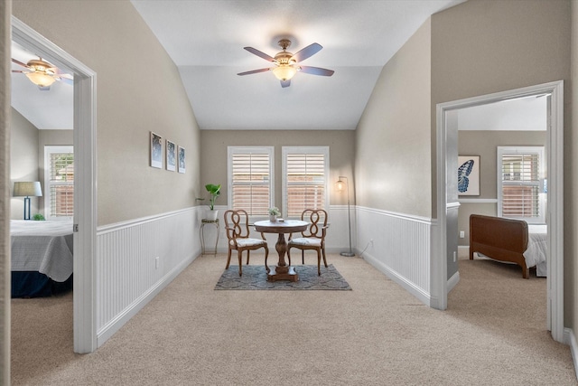 dining area featuring ceiling fan, carpet, a wealth of natural light, and lofted ceiling