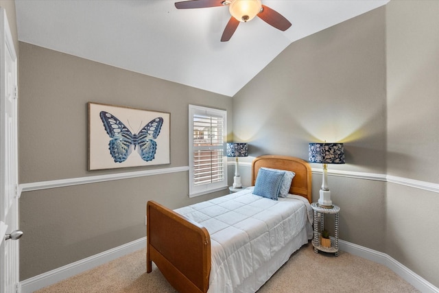 bedroom featuring carpet floors, a ceiling fan, baseboards, and vaulted ceiling