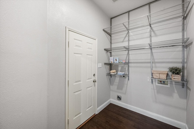 washroom featuring hookup for an electric dryer, laundry area, baseboards, hookup for a washing machine, and dark wood-type flooring