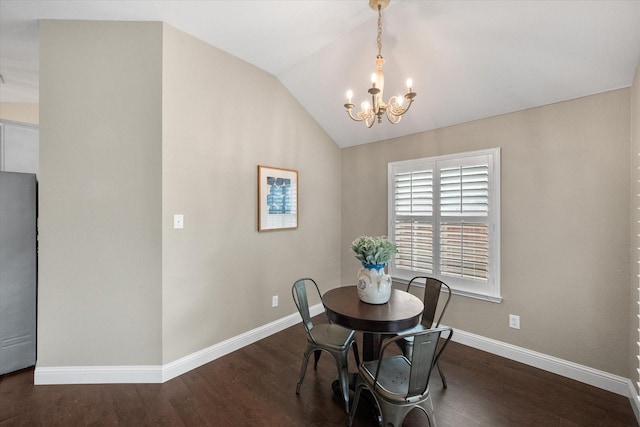dining space with an inviting chandelier, baseboards, wood finished floors, and lofted ceiling