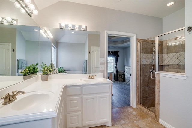 full bath with double vanity, a sink, and a stall shower