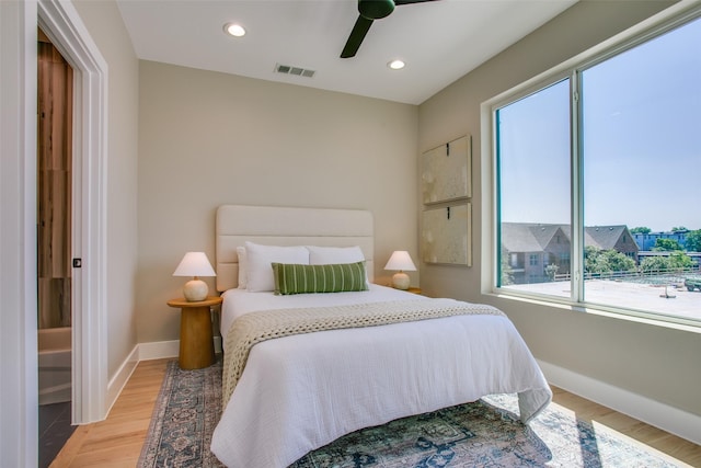 bedroom with light wood-style floors, baseboards, and visible vents