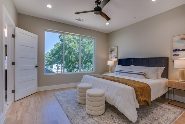 bedroom with ceiling fan, recessed lighting, baseboards, wood finished floors, and visible vents