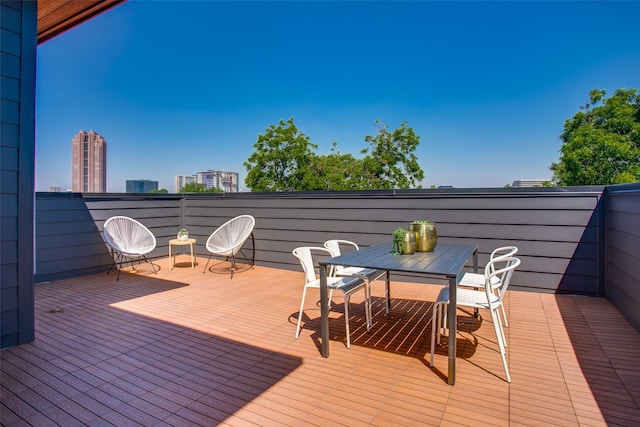wooden terrace featuring outdoor dining space