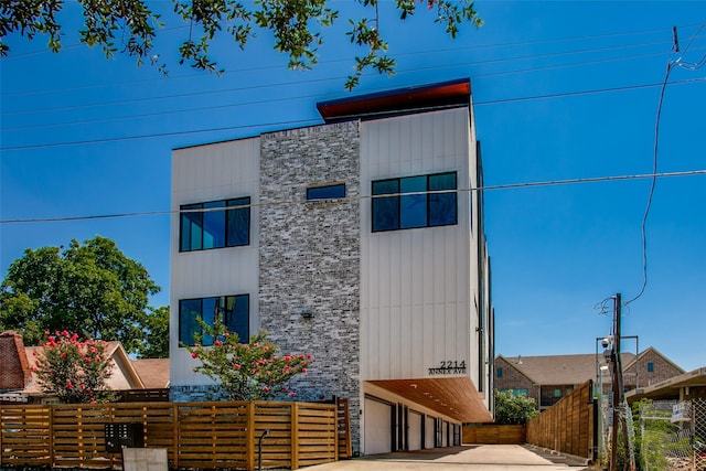 contemporary home with fence