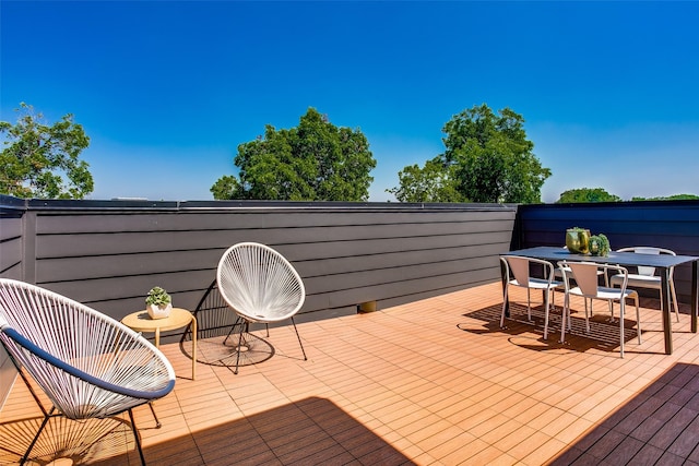 wooden deck with outdoor dining space