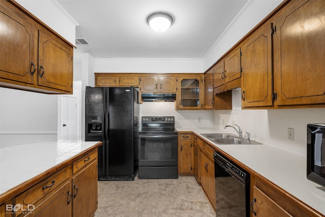 kitchen featuring visible vents, under cabinet range hood, brown cabinets, a sink, and black appliances