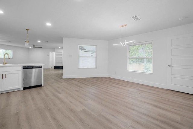 kitchen featuring stainless steel dishwasher, visible vents, an inviting chandelier, recessed lighting, and a sink