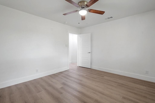 unfurnished room with a ceiling fan, baseboards, visible vents, and light wood finished floors