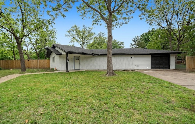 view of front facade with a garage, fence, driveway, and a front yard