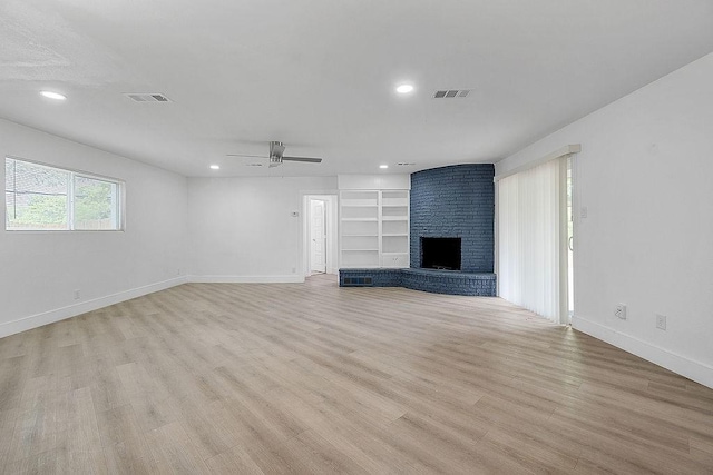unfurnished living room featuring baseboards, visible vents, ceiling fan, and light wood-style floors