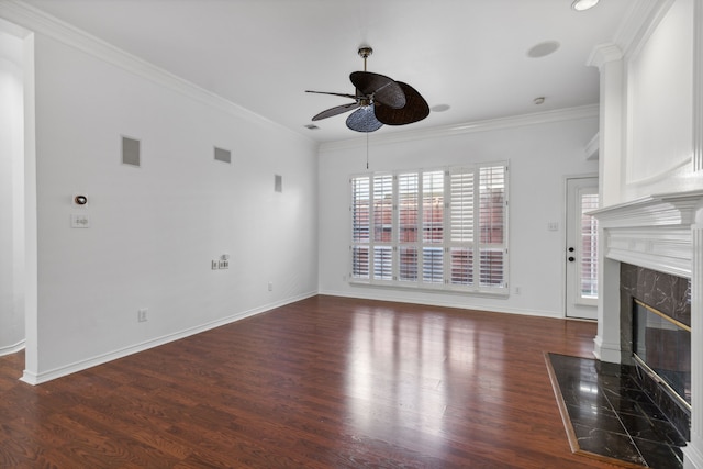 unfurnished living room featuring ornamental molding, wood finished floors, a fireplace, baseboards, and ceiling fan