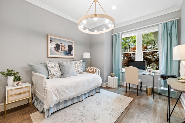 bedroom with baseboards, ornamental molding, wood finished floors, and a notable chandelier