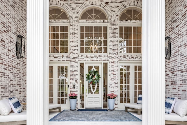 entrance to property featuring brick siding