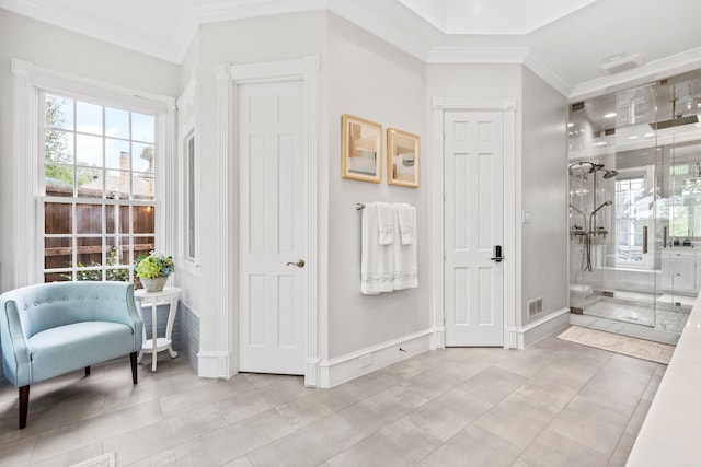 bathroom featuring crown molding, baseboards, tile patterned flooring, and a shower stall