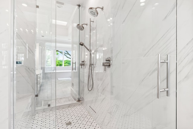 full bath with a marble finish shower and tile patterned floors