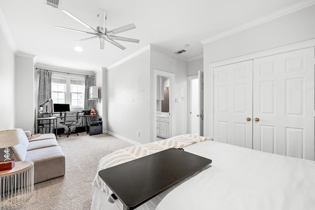carpeted bedroom with connected bathroom, baseboards, visible vents, and ornamental molding