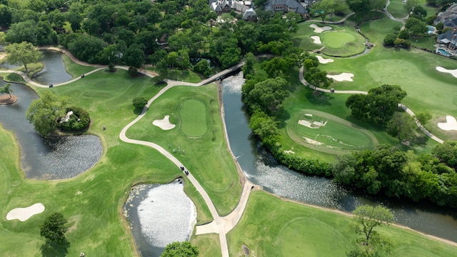 birds eye view of property with a water view and golf course view