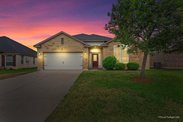 view of front facade featuring concrete driveway, an attached garage, stone siding, and a yard