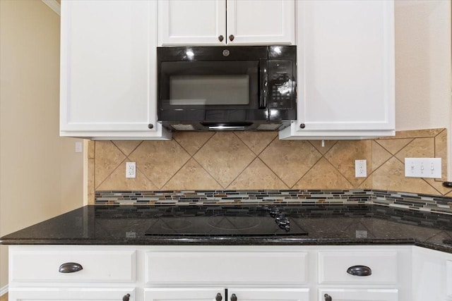 kitchen with white cabinets, black appliances, and tasteful backsplash