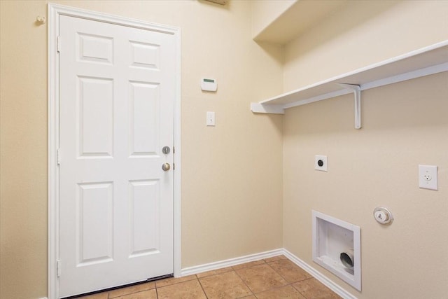 clothes washing area featuring laundry area, baseboards, hookup for an electric dryer, light tile patterned floors, and hookup for a gas dryer