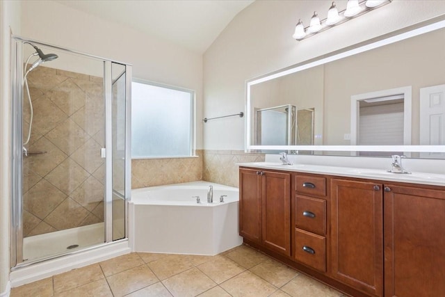 full bathroom featuring a sink, tile patterned floors, a stall shower, and lofted ceiling