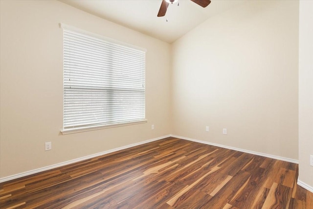 empty room featuring a ceiling fan, baseboards, lofted ceiling, and dark wood-type flooring