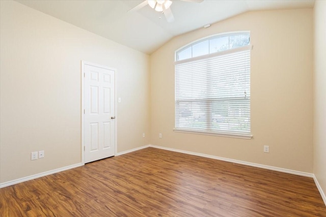 empty room featuring baseboards, ceiling fan, vaulted ceiling, and wood finished floors