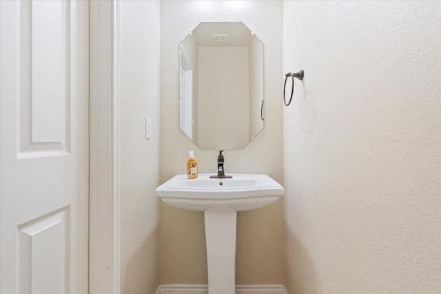 bathroom with a textured wall