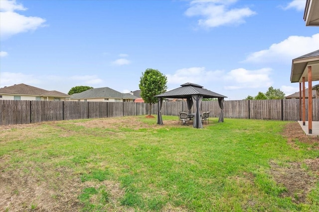 view of yard featuring a gazebo and a fenced backyard