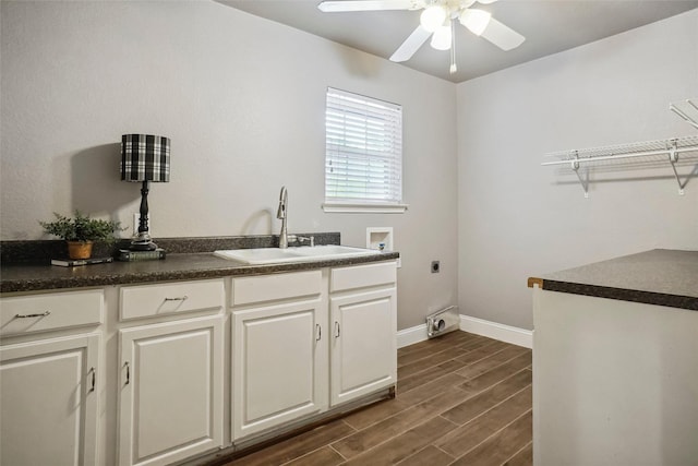 washroom featuring hookup for an electric dryer, a ceiling fan, a sink, hookup for a washing machine, and dark wood-type flooring