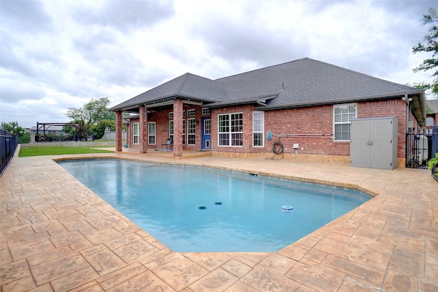 pool featuring a patio and fence