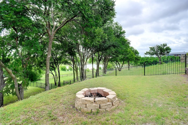 view of yard featuring fence and a fire pit