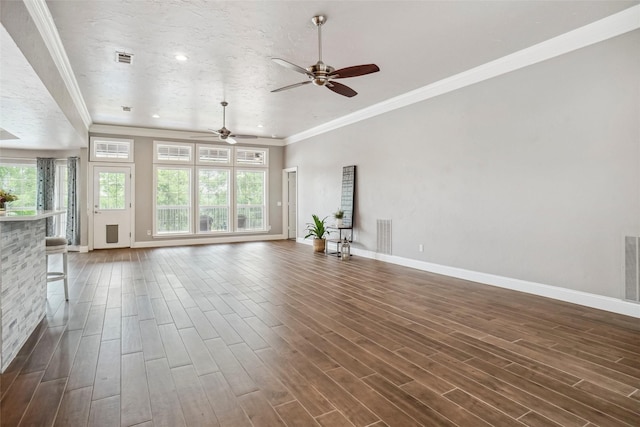 unfurnished living room featuring a ceiling fan, baseboards, and plenty of natural light