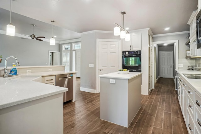 kitchen with crown molding, a center island, a sink, dark wood finished floors, and black appliances